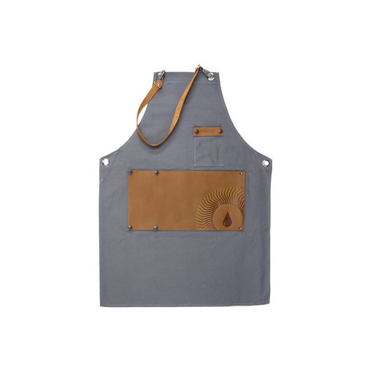 ###
A close-up image of a Pesado Barista Apron with adjustable straps and multiple pockets for holding barista tools and accessories 